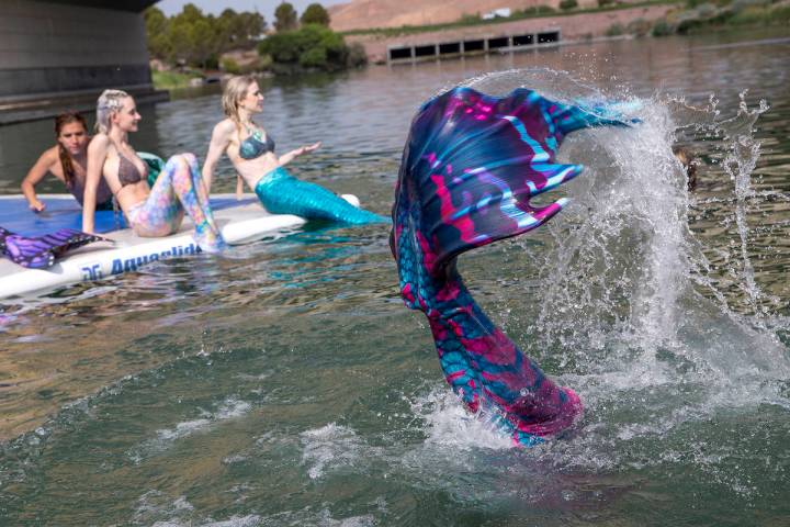 Mermaids sun themselves and splash around at Lake Las Vegas on Saturday, June 19, 2021, in Hend ...