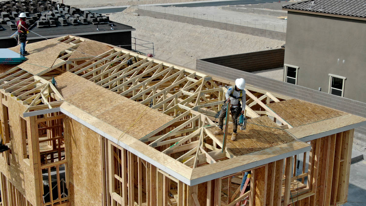 An aerial view of home construction workers in Cascades, a housing development near Far Hills A ...