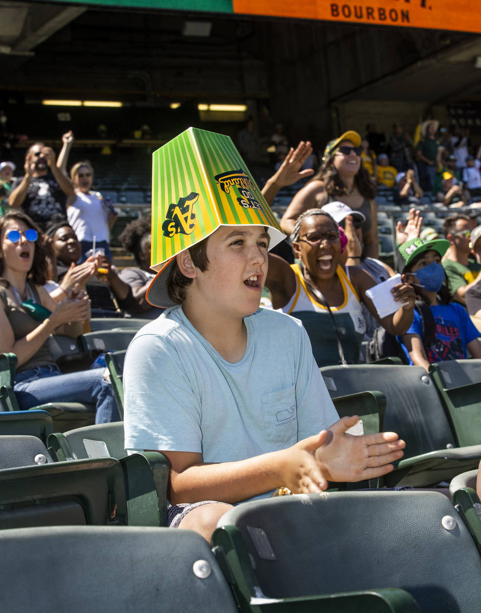Oakland A‘s fan Sheb Bellias, 12, cheers with an empty popcorn container on his head while pl ...