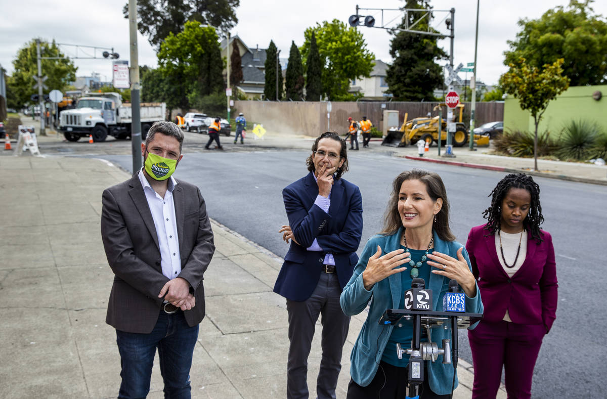 Oakland Mayor Libby Schaaf, right center, speaks at a press conference on Friday, July 2, 2021, ...