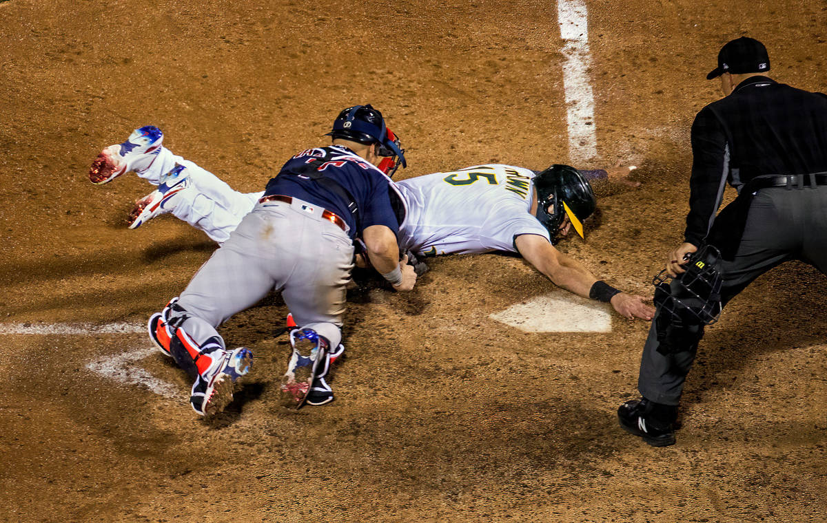 Boston Red Sox catcher Christian Vazquez (7) tags out Oakland A‘s runner Seth Brown (15) at h ...