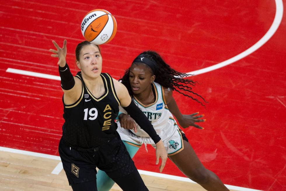 Las Vegas Aces center JiSu Park (19) reaches for control of the ball while New York Liberty for ...