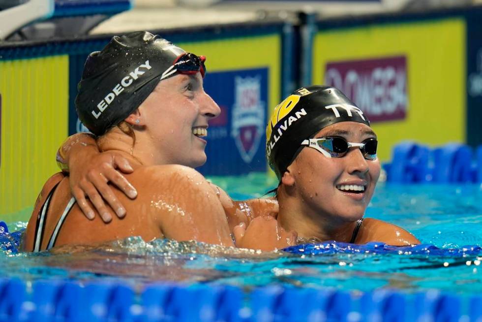 Katie Ledecky hugs Erica Sullivan after winning the women's 1500 freestyle during wave 2 of the ...