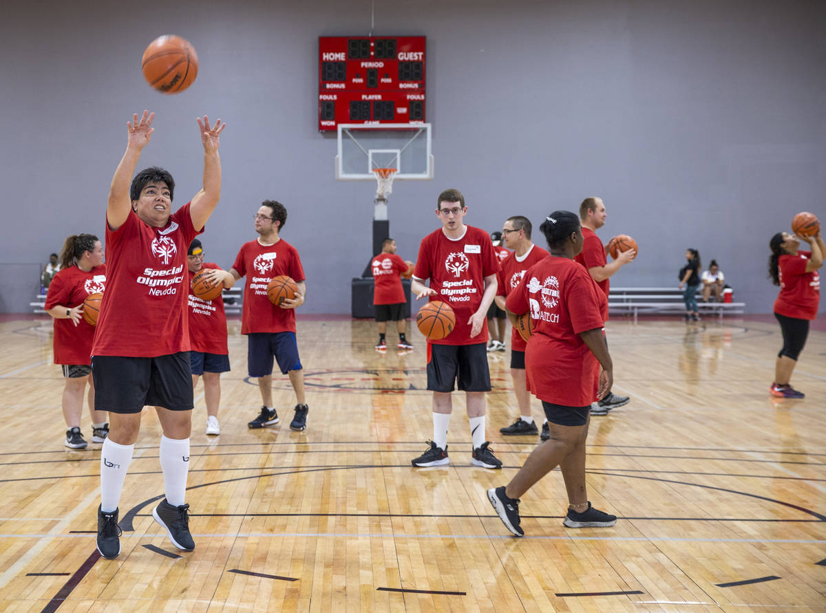 Players warm up with some shooting as the Special Olympics Nevada hosts a basketball clinic wit ...