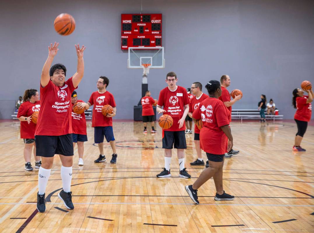 Players warm up with some shooting as the Special Olympics Nevada hosts a basketball clinic wit ...