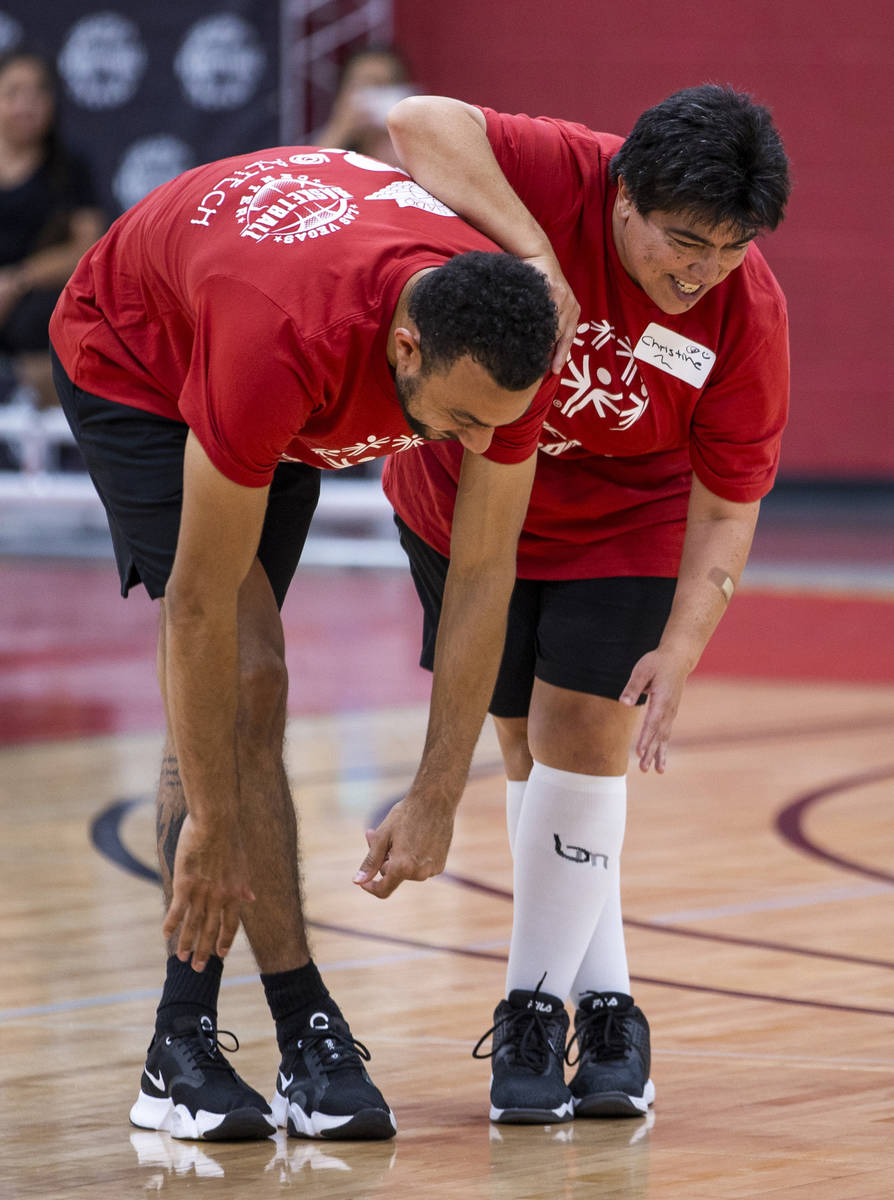 Professional basketball player Nigel Williams-Goss, left, warms up with young player Christine ...
