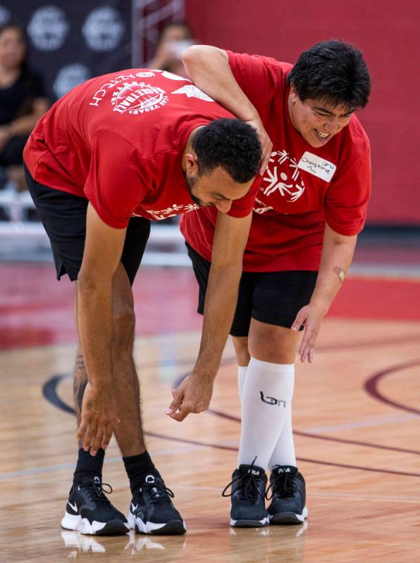 Professional basketball player Nigel Williams-Goss, left, warms up with young player Christine ...