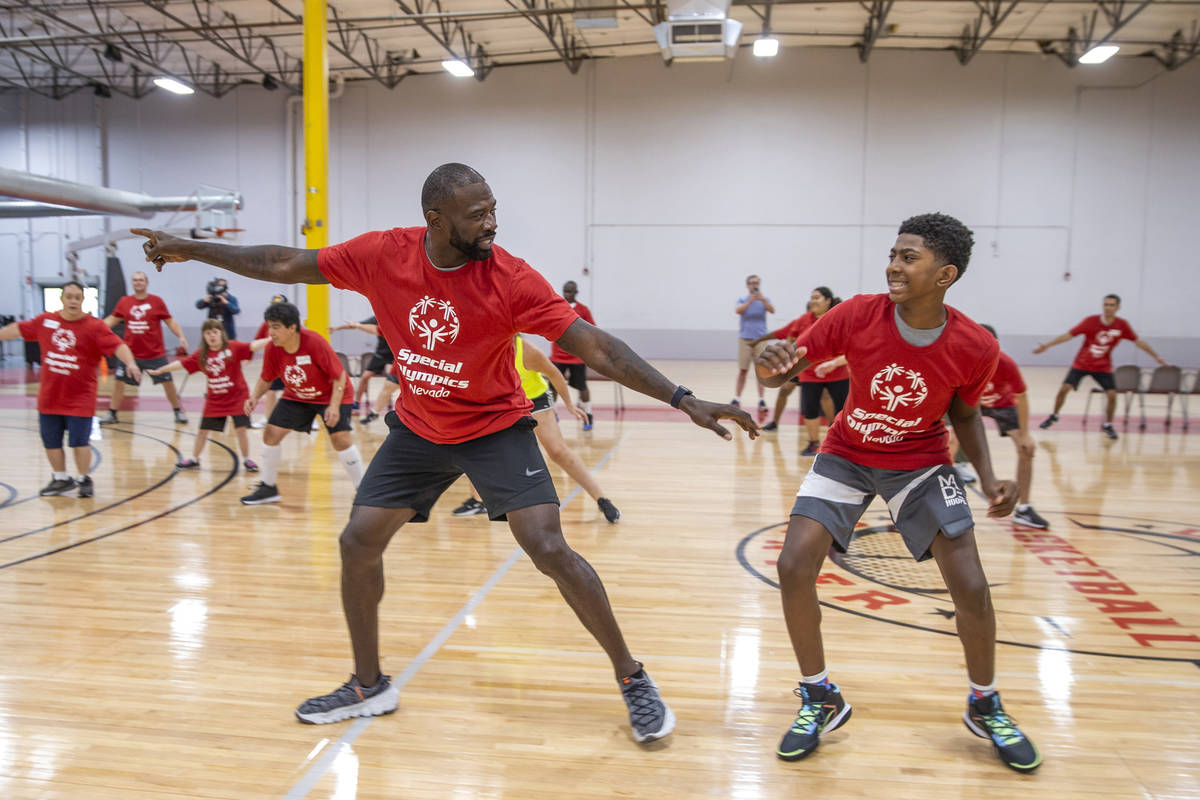 Two-time NBA Slam Dunk Champion Jason Richardson, left, and son Jaxon, 13, lead a warm up drill ...