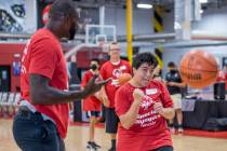 Two-time NBA Slam Dunk Champion Jason Richardson congratulates player Christine McCullough afte ...