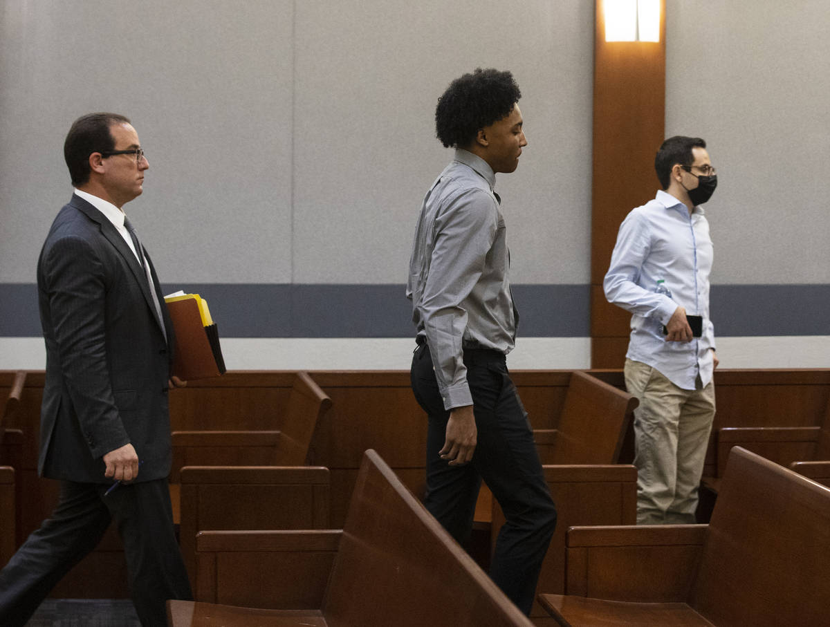 Former Bishop Gorman High School basketball standout Zaon Collins, center, and his attorney Ric ...
