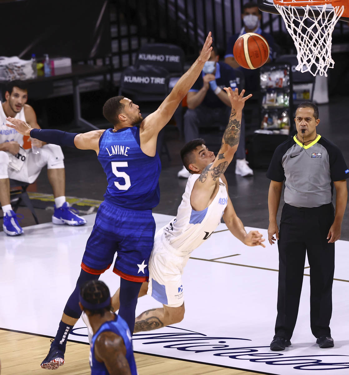 Argentina’s Gabriel Deck, right, lays up the ball under pressure from USA’s Zach ...