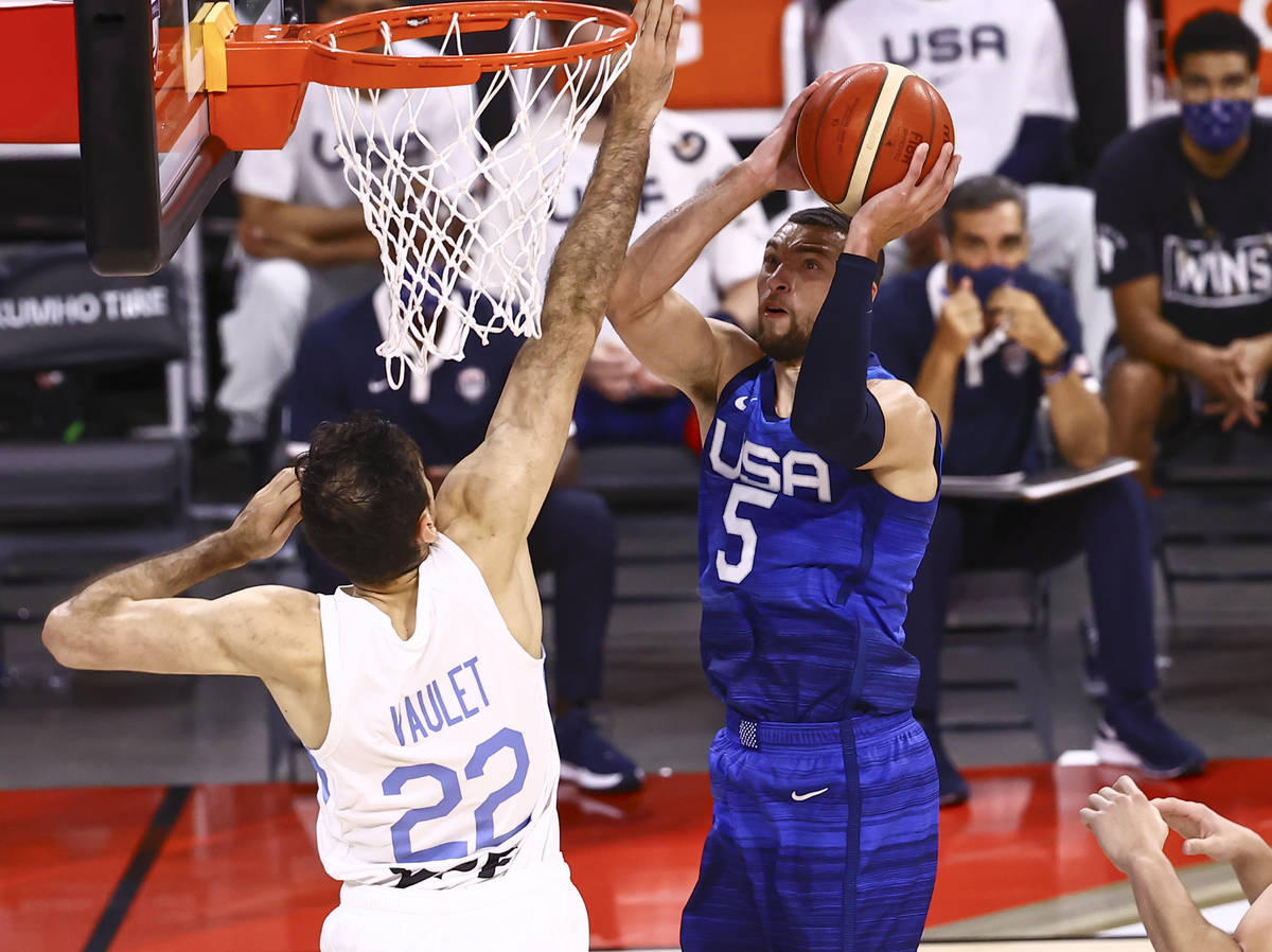 USAÕs Zach Lavine (5) shoots around ArgentinaÕs Juan Pablo Vaulet (22) during the fir ...