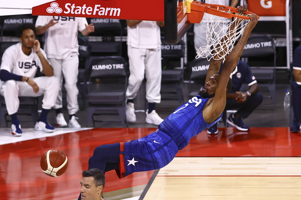 USA's Kevin Durant (7) dunks the ball over Argentina's Luis Scola during the first half of an e ...