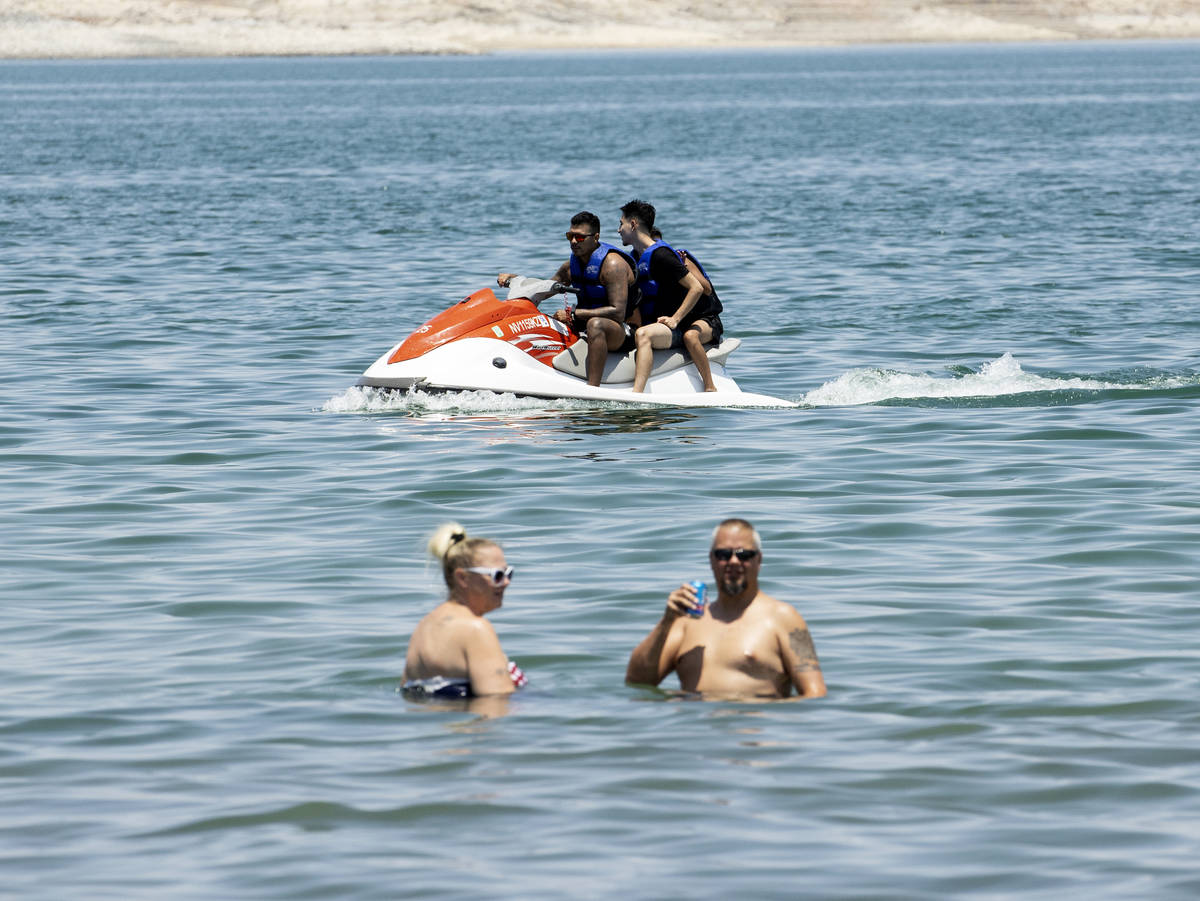 People relax at Boulder Beach in the Lake Mead National Recreation Area, on Friday, July 2, 202 ...