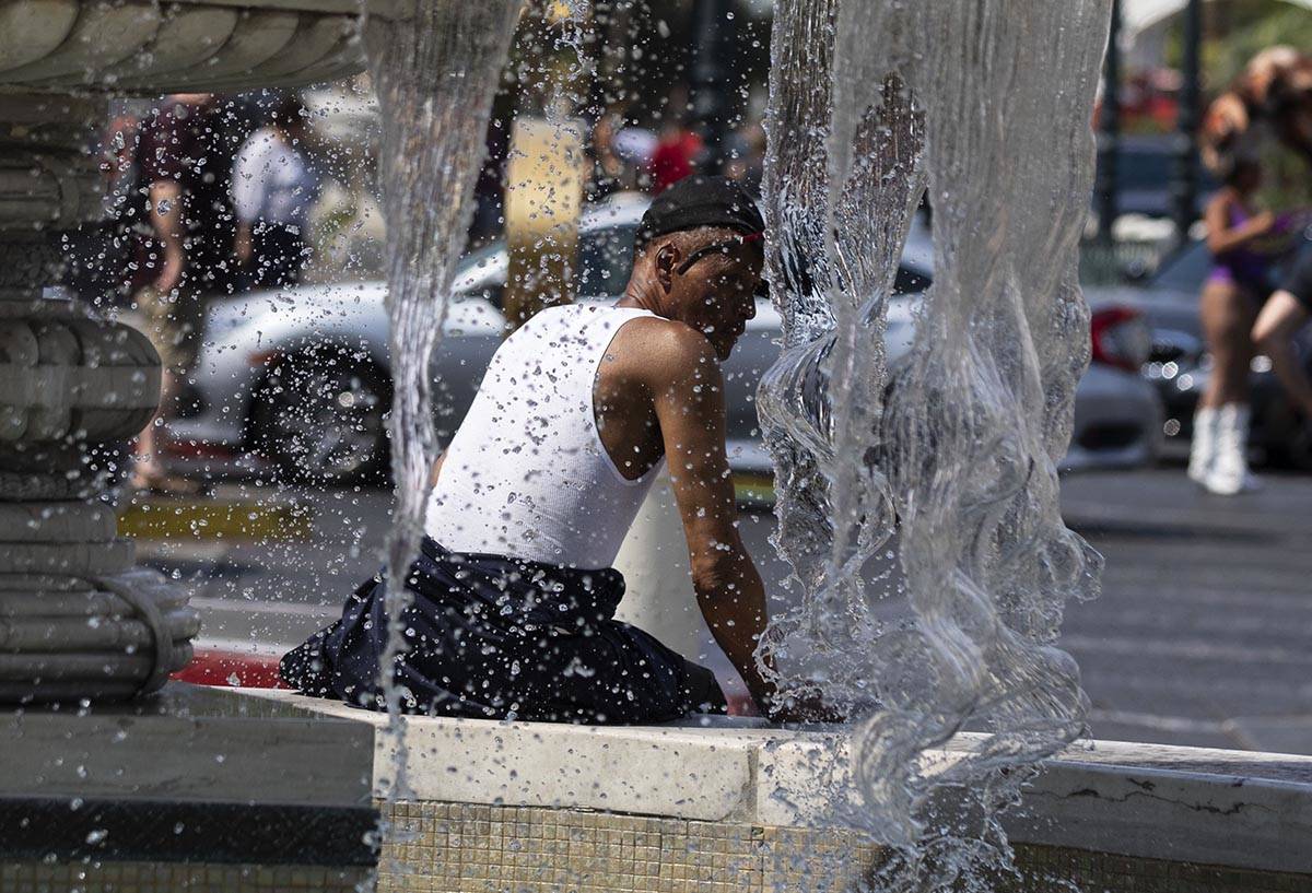 Darrick Washington takes a break next to the Venetian fountain, on Friday, June 18, 2021, in La ...
