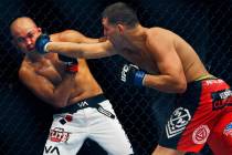 Nick Diaz, right, lands a right hand to the face of BJ Penn during the main event at UFC 137 at ...