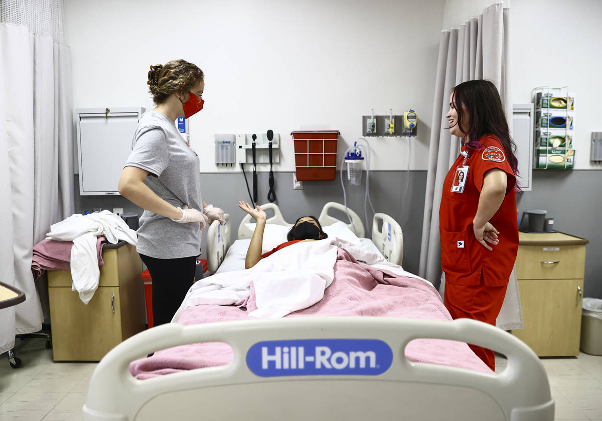 West Career & Technical Academy student Jenna Le Piere, left, learns about hospital bed orienta ...