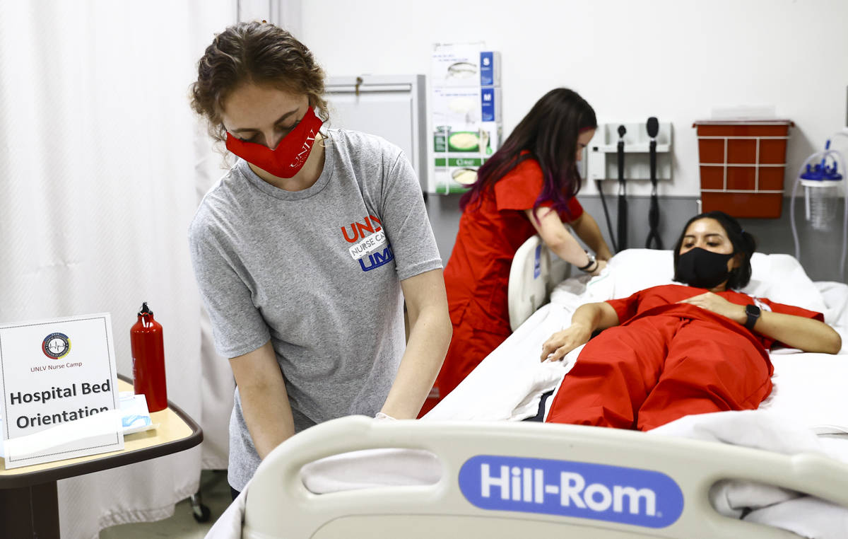 West Career & Technical Academy student Jenna Le Piere, left, participates at the hospital bed ...