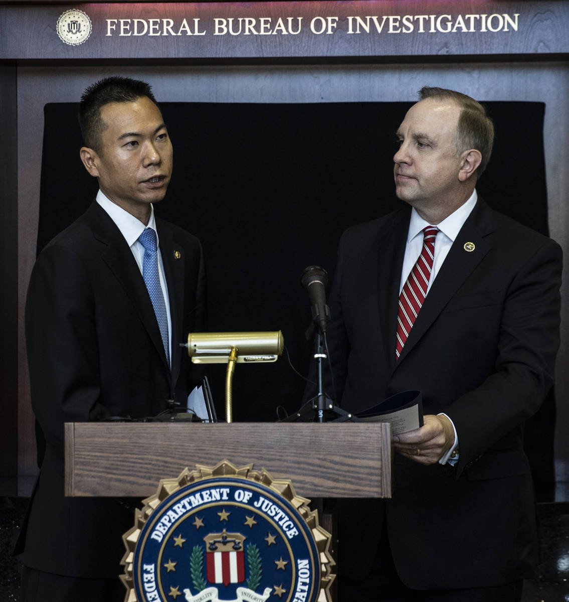 Acting U.S. Attorney Christopher Chiou, left, speaks about a global law enforcement action as S ...