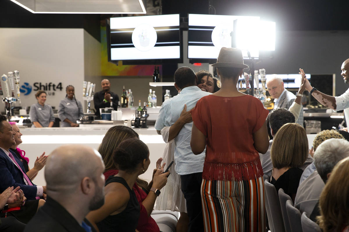 Felicia Parker, owner of Any Occasion Baskets, hugs her loved ones after winning the "Small Bus ...