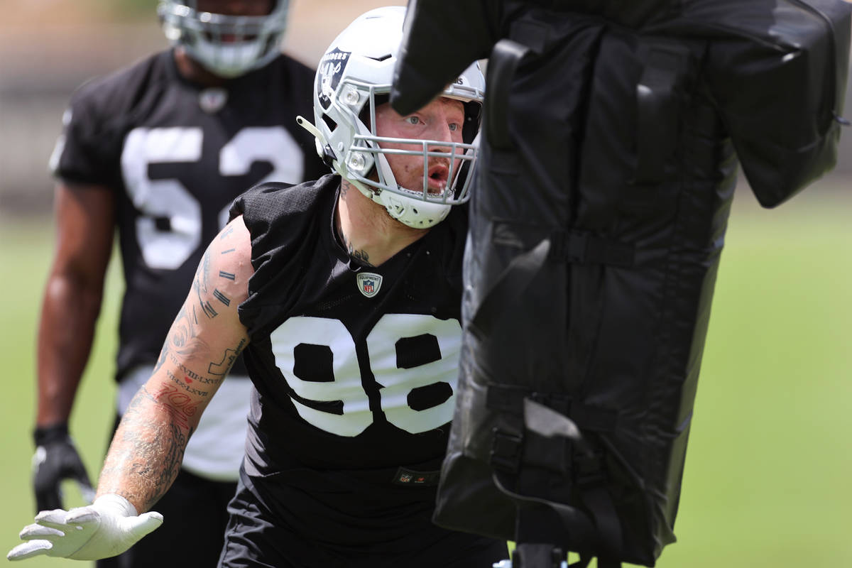 Las Vegas Raiders defensive end Maxx Crosby (98) runs a drill during a team practice at the Rai ...