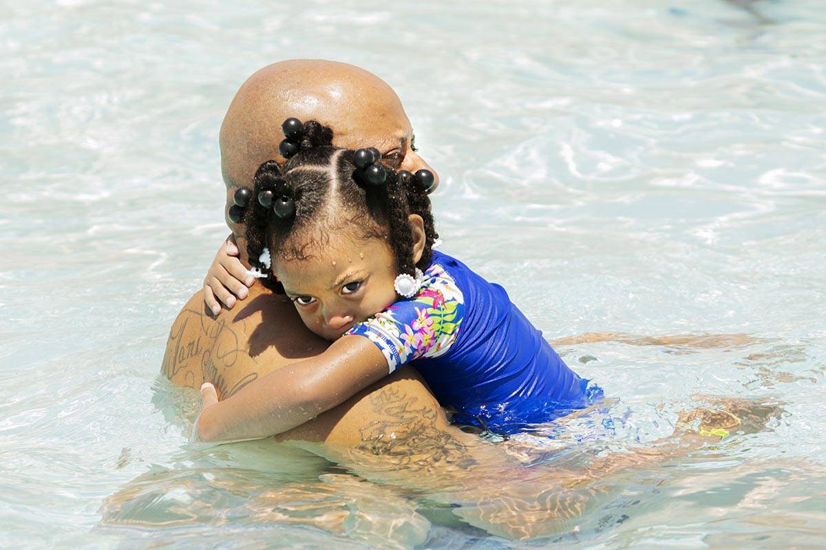 Gregory Henderson holds his daughter London, 3, in the swimming pool at the Desert Breeze Aquat ...