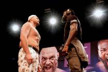 WBC Heavyweight Champion Tyson Fury, left and Deontay Wilder face off at a news conference in L ...