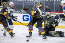 Golden Knights defenseman Alec Martinez (23) slaps a puck down with St. Louis Blues left wing Z ...
