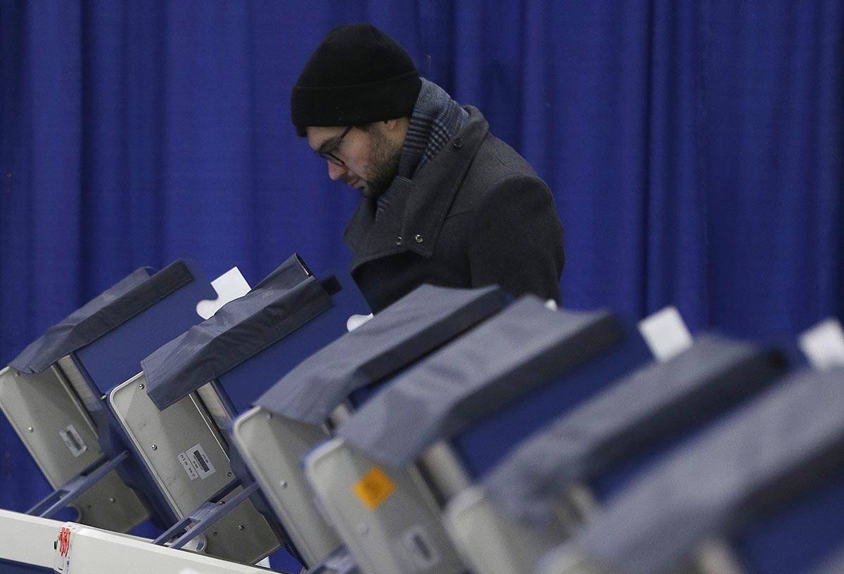 In this Tuesday, March 13, 2018 photo, Chicago resident Kurt Kamrath casts his ballot in Illino ...