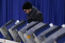 In this Tuesday, March 13, 2018 photo, Chicago resident Kurt Kamrath casts his ballot in Illino ...