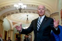 President Joe Biden speaks with members of the media after leaving a meeting with fellow Democr ...