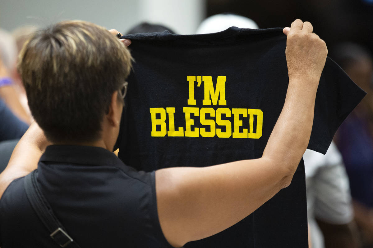 A customer checks out a t-shirt at the opening of Marshawn Lynch' store Beast Mode in The Shopp ...