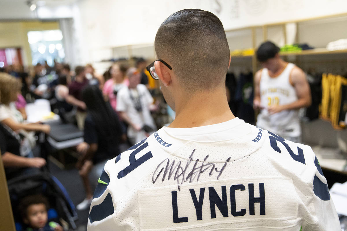Esteban Soto, of Las Vegas, shows off his autographed Marshawn Lynch jersey at the opening of t ...