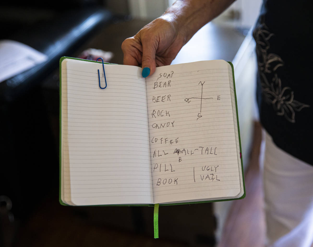 Donna Peterson shows some of the notes in a journal belonging to her husband, Byron Peterson, n ...