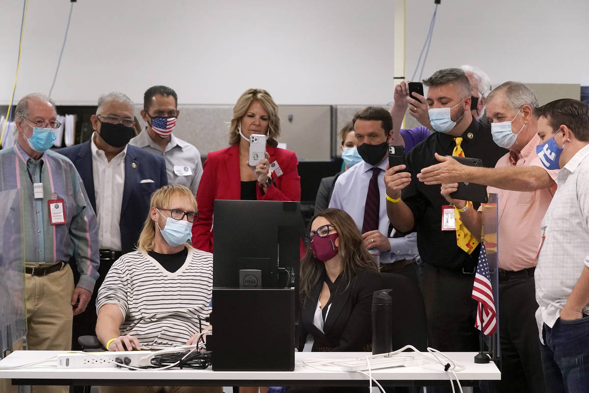 FILE - In this Wednesday, Nov. 18, 2020 file photo, Arizona election staff, other state officia ...