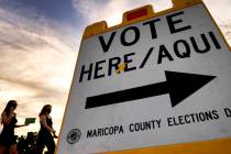 In this Nov. 3, 2020, file photo voters deliver their ballot to a polling station in Tempe, Ari ...