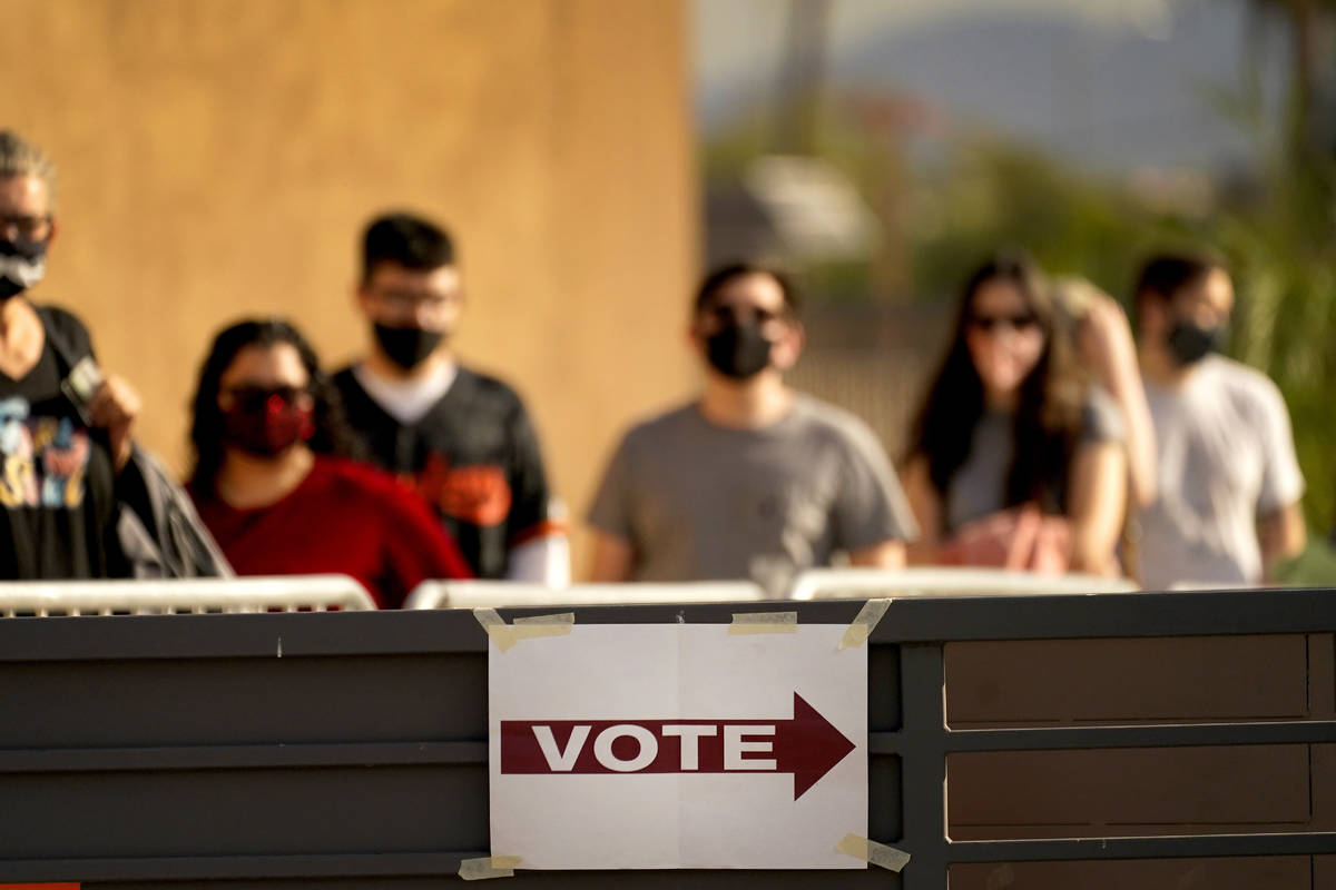 FILE - In this Tuesday, Nov. 3, 2020 file photo, Voters stand in line outside a polling station ...
