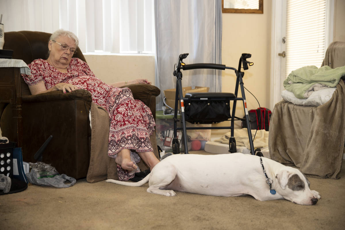 Shirley Soiset, 77, whose rent is going up by about $300 a month, with her service dog inside o ...