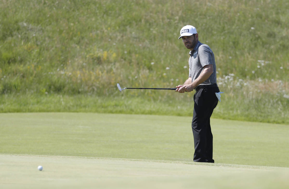 South Africa's Louis Oosthuizen putts on the 3rd hole during the final round of the British Ope ...