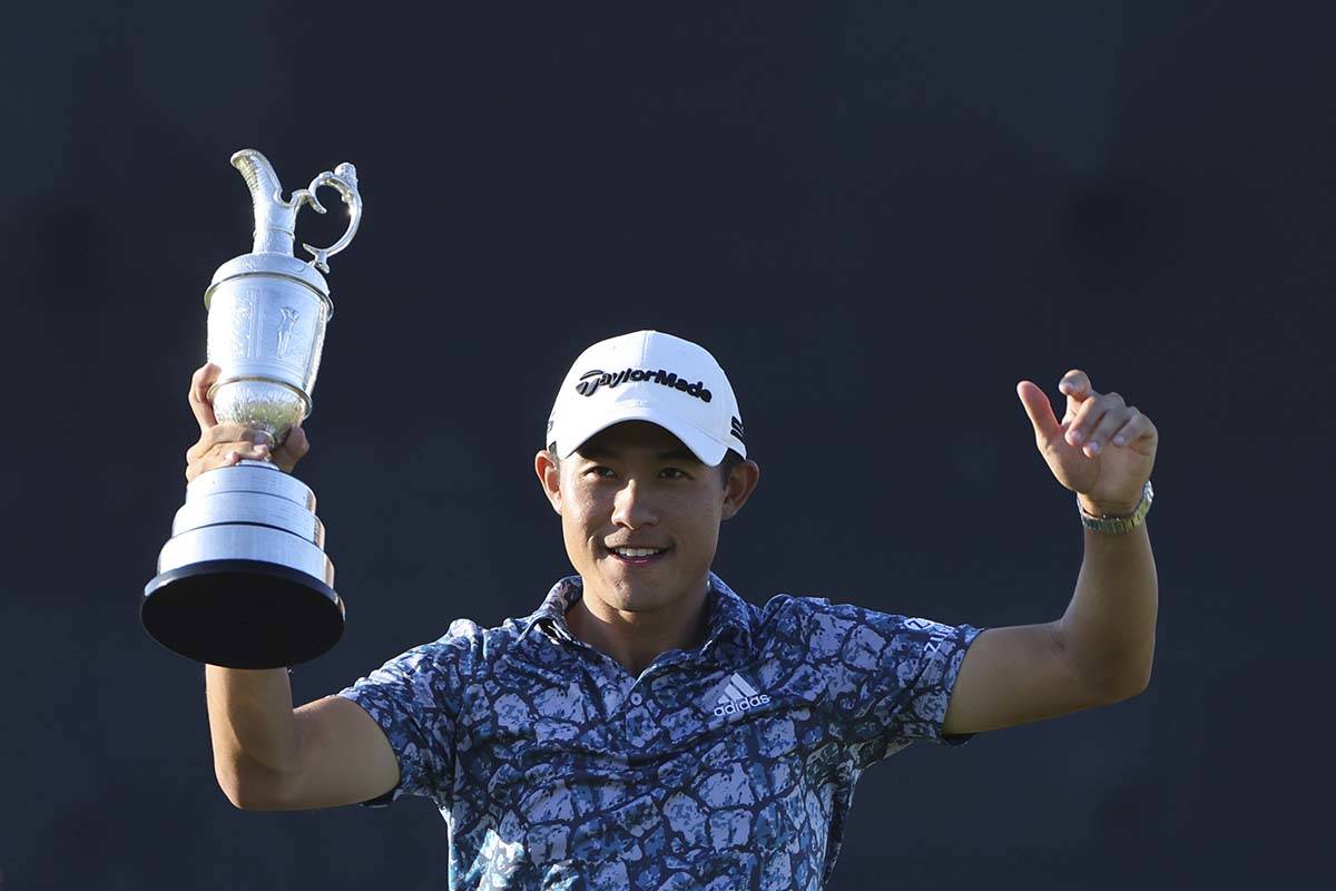 United States' Collin Morikawa holds up the claret jug trophy as he poses for photographers on ...