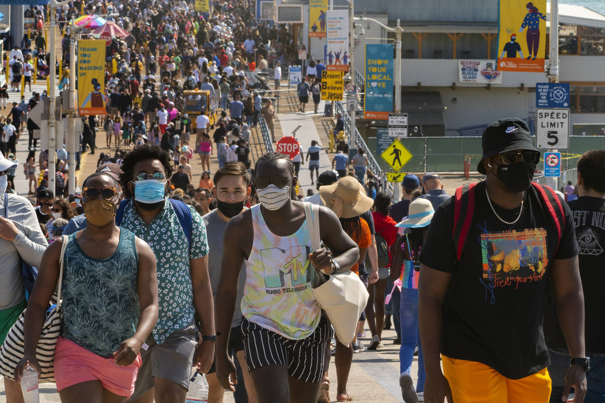 FILE - In this May 29, 2021, file photo, people crowd the Santa Monica Pier in Santa Monica, Ca ...