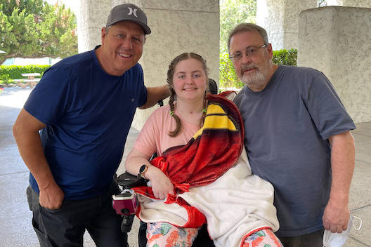 Emma Burkey with her father Russ, right, and Bret Johnson, left. (Burkey Family)