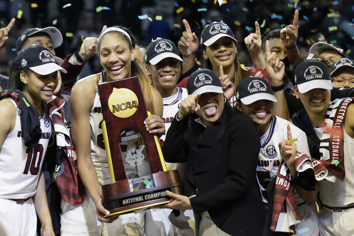 South Carolina forward A'ja Wilson holds the trophy and coach Dawn Staley points as the team ce ...