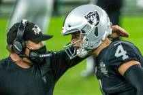 Raiders head coach Jon Gruden comes together on the sidelines with Raiders quarterback Derek Ca ...