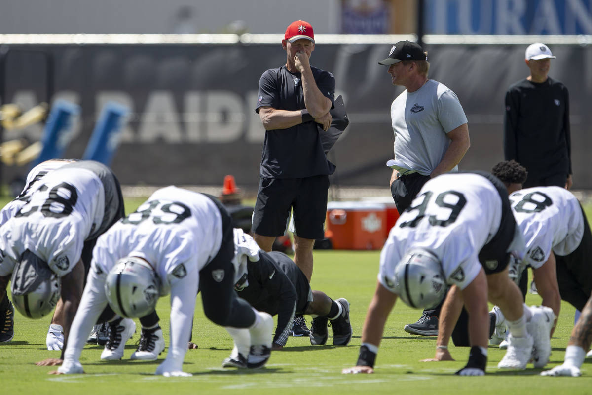 Raiders general manager Mike Mayock, left, and head coach Jon Gruden watch the team stretch dur ...