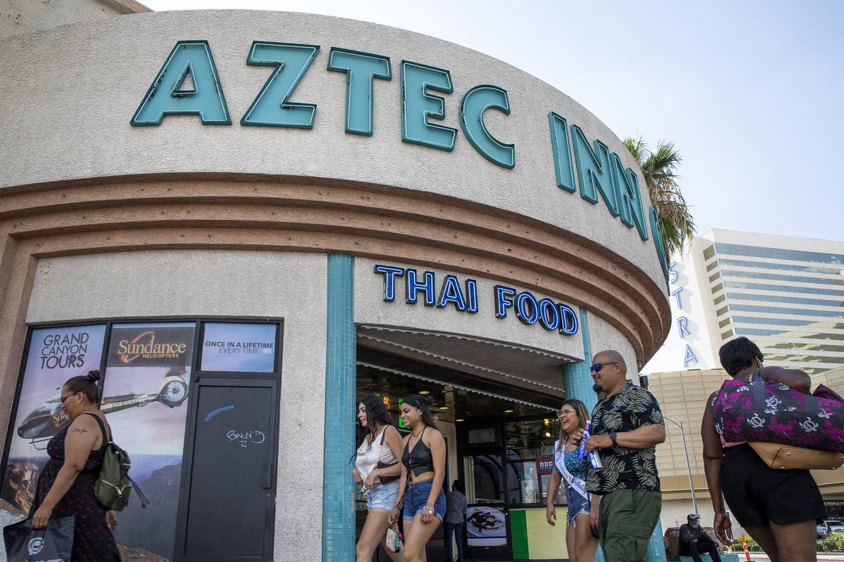 Pedestrians walk past Aztec Inn Casino, a property for sale on Las Vegas Boulevard, on Tuesday, ...