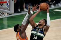Milwaukee Bucks forward Giannis Antetokounmpo (34) shoots against Phoenix Suns center Deandre A ...