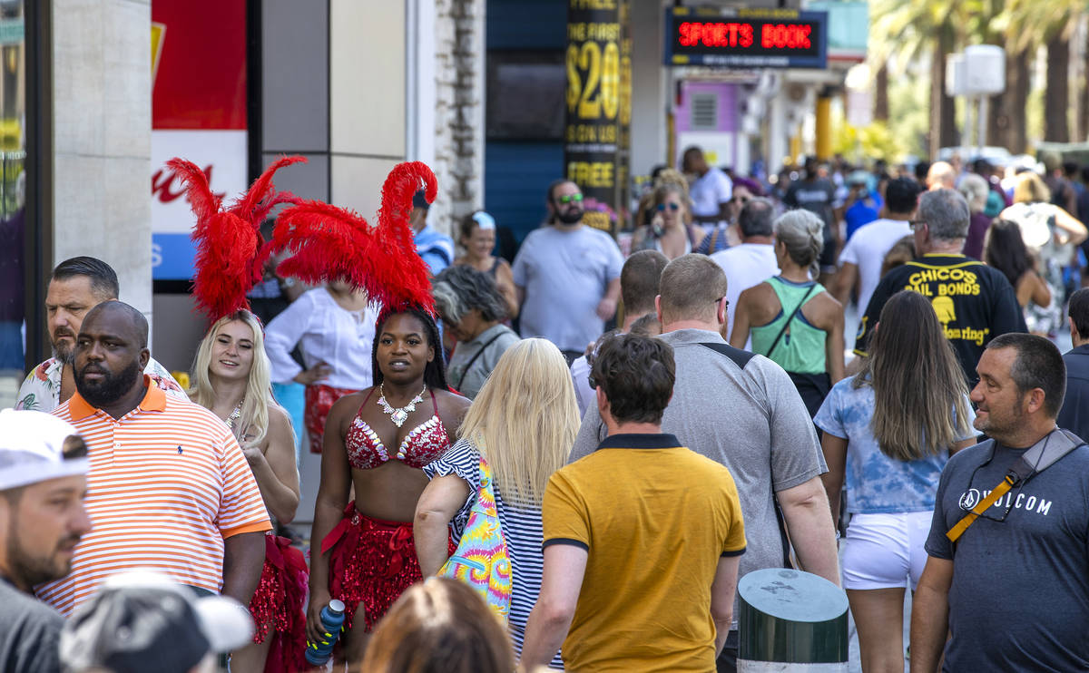 People walk along the Strip near The Venetian, most not wearing mask, on Friday, July 16, 2021, ...