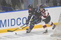 Fargo Force defenseman Scott Morrow (24) and Chicago Steel forward Sam Lipkin (28) battle for t ...