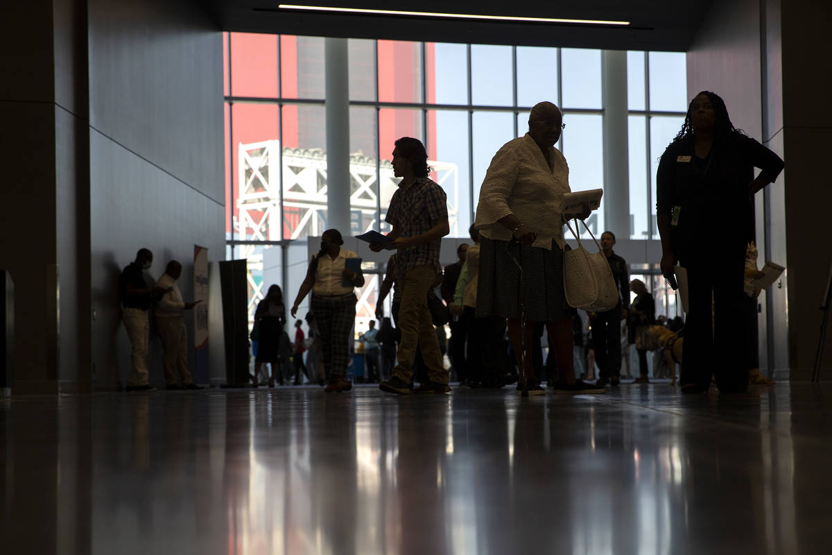 People enter the Las Vegas Convention Center for a summer job fair hosted by Clark County on Fr ...